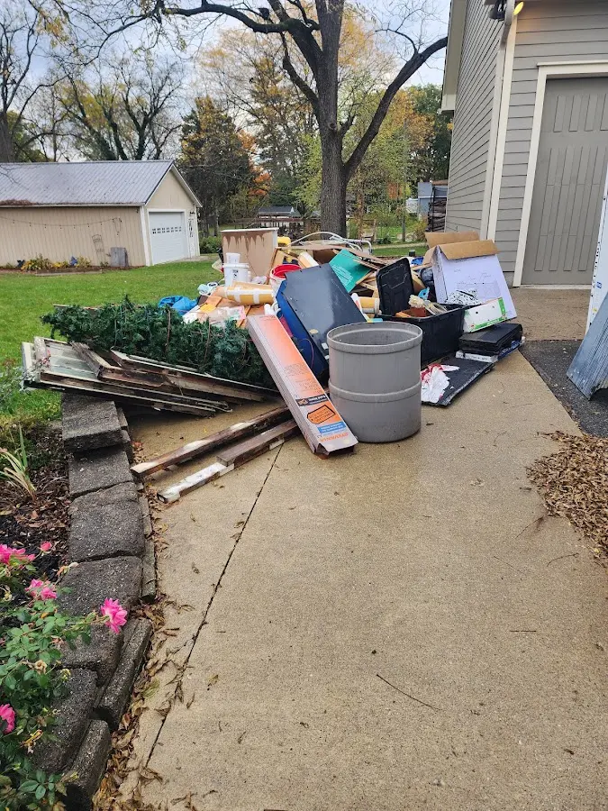 Dumpster being loaded with debris for Residential Dumpster Rental in Norwood Young America